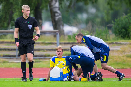 Olle Samuelsson of Sweden receives medical attention by