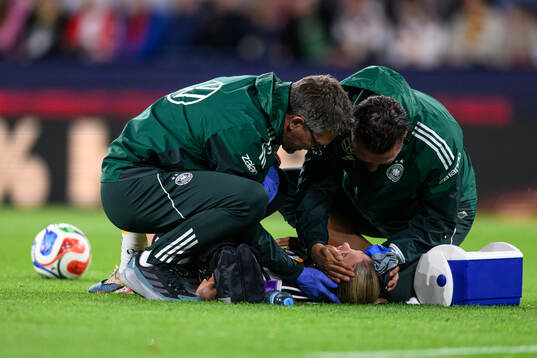 Elisa Senß of Germany in pain and receives medical