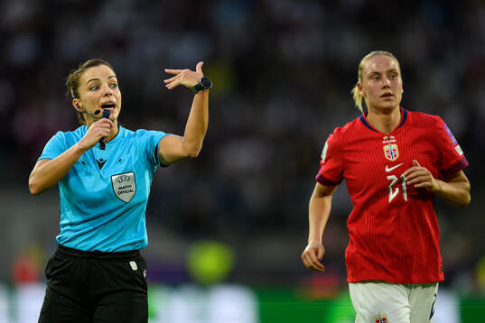 Referee Marta Huerta De Aza and Lisa Naalsund of Norway