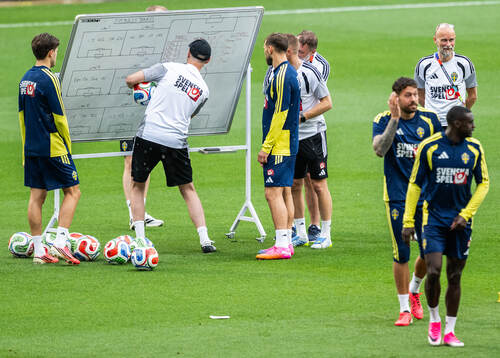 Assistant coach Andreas Georgson instructs players of the