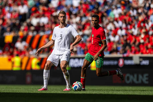 Kristoffer Ajer of Norway and Azzedine Ounahi of Morocco