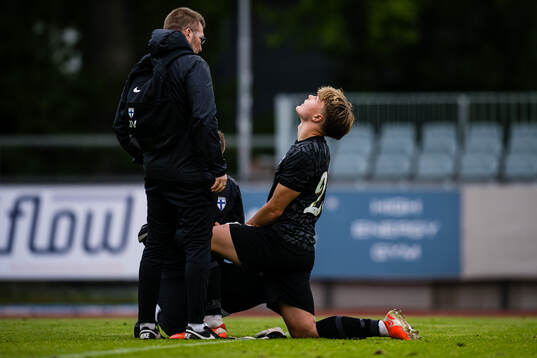 Goalkeeper Ukko Happonen of Finland in pain