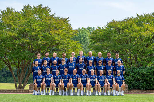 Staff of the Norwegian national football team pose for a