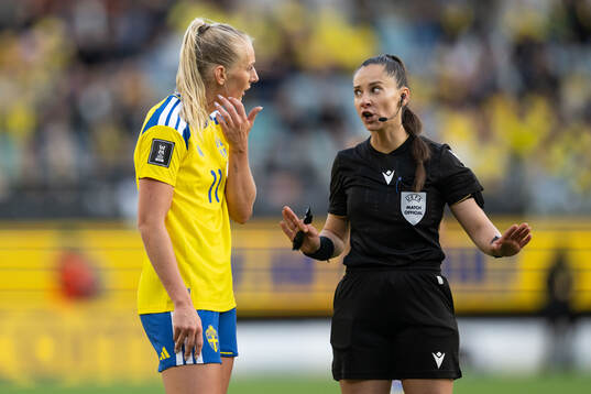 Stina Blackstenius of Sweden and referee Iuliana Demetrescu