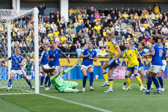 Fridolina Rolfö of Sweden scores 2-2 behind goalkeeper