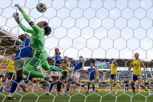 Hanna Lundkvist of Sweden scores 1-2 behind goalkeeper