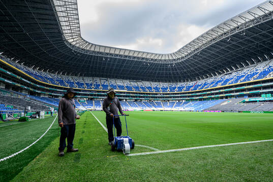 Workers prepare the pitch