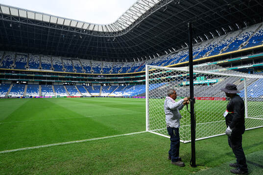 Workers prepare the goal net