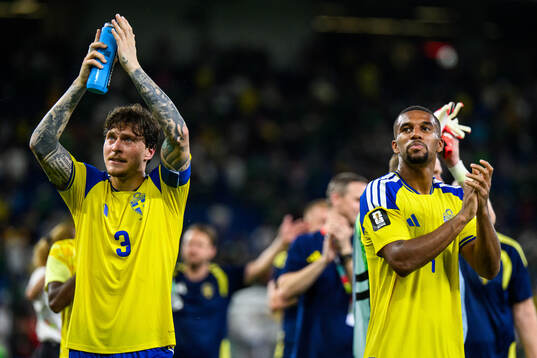 Victor Nilsson Lindelöf and Isak Hien of Sweden celebrate