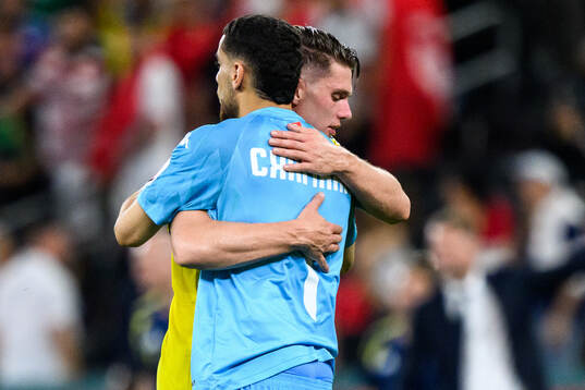 Viktor Gyökeres of Sweden and goalkeeper Mouhib Chamakh of