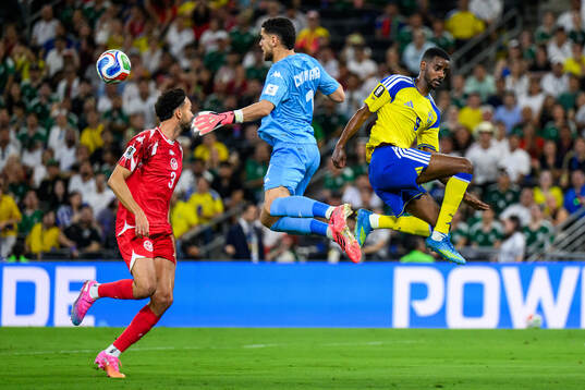 Montassar Talbi and goalkeeper Mouhib Chamakh of Tunisia