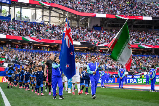Chris Wood of New Zealand and Mehdi Taremi of Iran