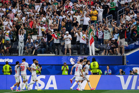 Ramin Rezaeian of Iran celebrate with teammates