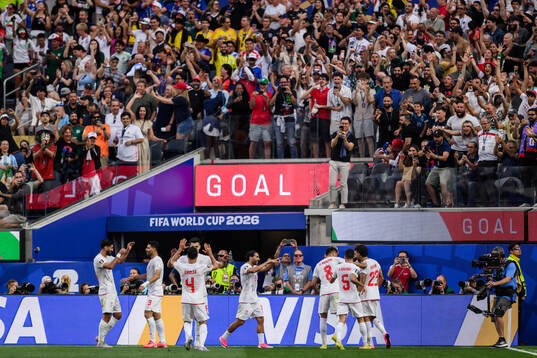 Ramin Rezaeian of Iran celebrate with teammates