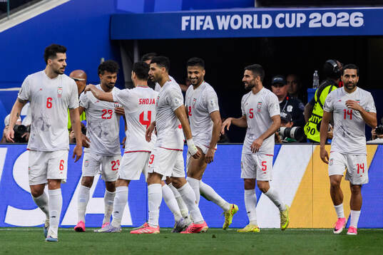 Ramin Rezaeian of Iran celebrate with teammates