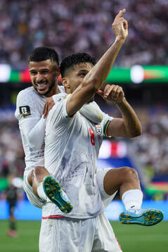 Mehdi Ghayedi and Mohammad Mohebbi of Iran celebrate