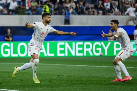 Mohammad Mohebbi and Mehdi Taremi of Iran celebrates