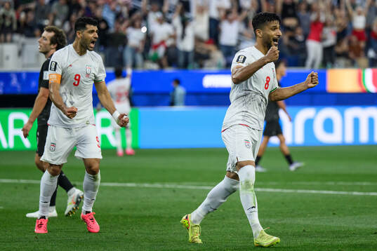 Mehdi Taremi and Mohammad Mohebbi of Iran celebrate