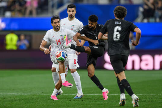 Saman Ghoddos of Iran and Sarpreet Singh of New Zealand