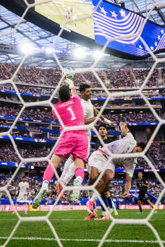 Goalkeeper Max Crocombe of New Zealand boxes the ball in