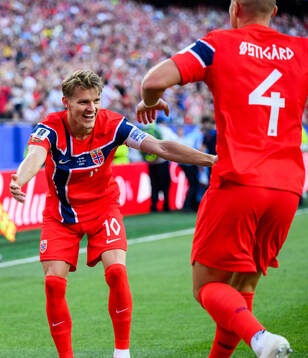 Martin Ødegaard and Leo Østigård of Norway celebrate