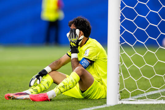 Goalkeeper Jalal Hasan Hachim of Iraq looks dejected