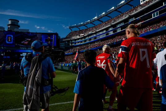 Julian Ryerson and Erling Braut Haaland of Norway enter the
