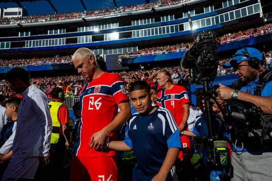 Julian Ryerson and Erling Braut Haaland of Norway enter the