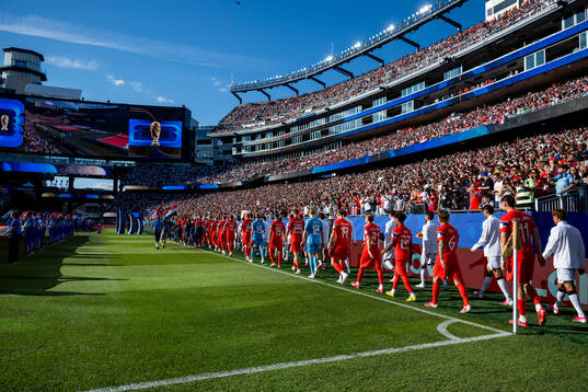 The teams enter the pitch