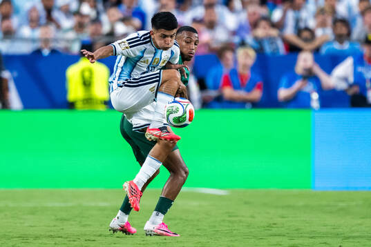 Thiago Almada and Rafik Belghali of Algeria