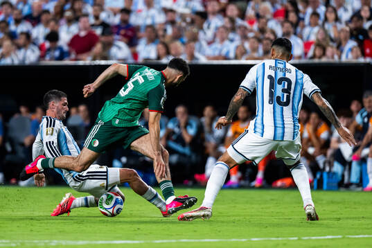 Rodrigo De Paul and Cristian Romero of Argentina as well as