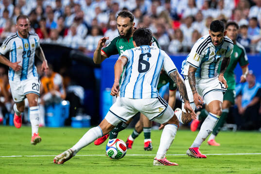 Amine Gouiri of Algeria and Lisandro Martinez of Argentina