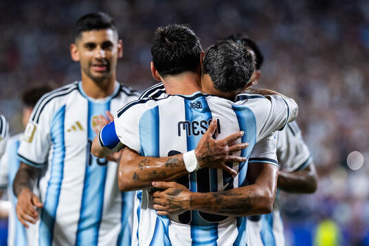 Lionel Messi and Facundo Medina celebrate