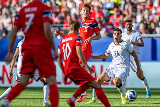 Sander Berge of Norway and Zaid Ismael Khaleel Al-Dulaimi