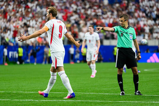 Referee Clement Turpin gives penalty to England