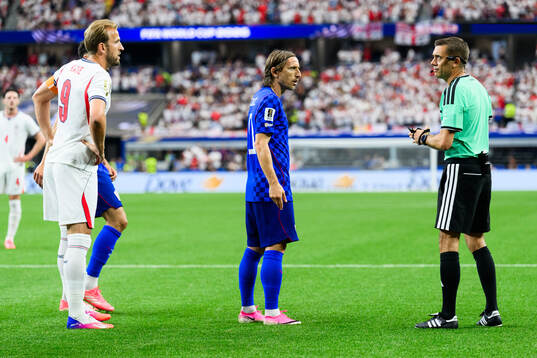 Harry Kane of England, Luka Modric of Croatia and Referee