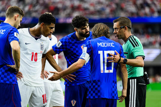 Luka Modric of Croatia and Referee Clement Turpin