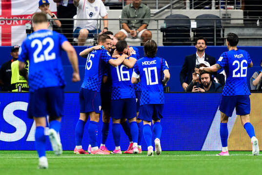 Martin Baturina and teammates of Croatia celebrate 1-1