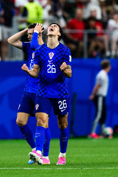 Petar Musa of Croatia celebrates scoring 2-2
