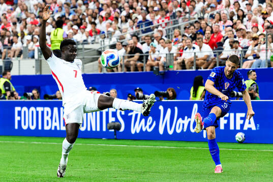 Bukayo Saka of England and Andrej Kramaric of Croatia