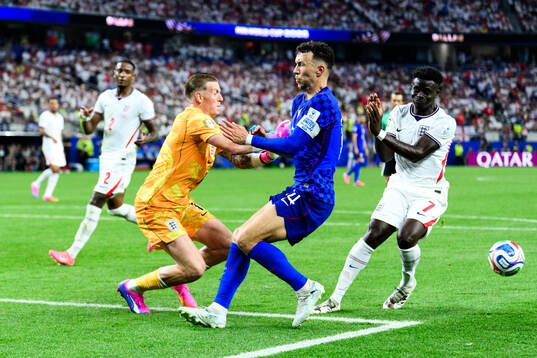Goalkeeper Jordan Pickford and Bukayo Saka of England and