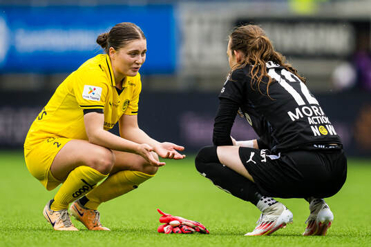 Amie Sannes and goalkeeper Michaela Karin Moran of