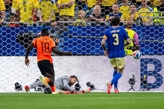 Brian Brobbey of Netherlands scores 1-0 behind goalkeeper