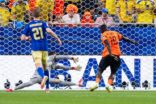 Brian Brobbey of Netherlands scores 1-0 behind goalkeeper