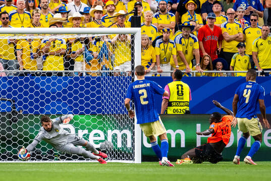Brian Brobbey of Netherlands scores 2-0 behind goalkeeper