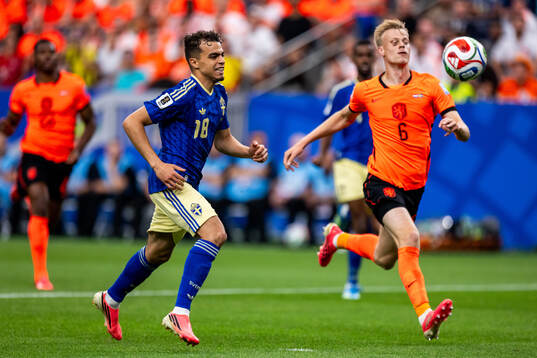 Yasin Ayari of Sweden and Jan Paul Van Hecke of Netherlands