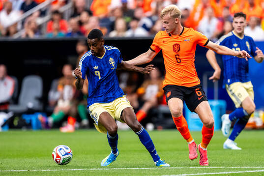 Alexander Isak of Sweden and Jan Paul Van Hecke of