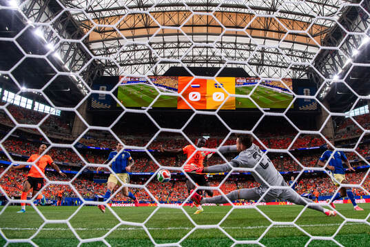 Brian Brobbey of Netherlands scores 1-0 behind goalkeeper