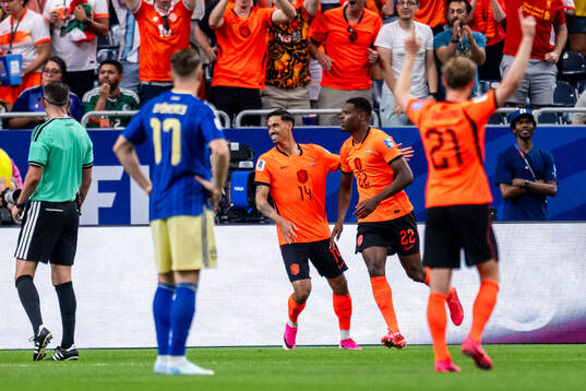 Tijjani Reijnders and Denzel Dumfries of Netherlands