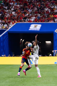 Marc Cucurella of Spain and Musab Aljuwayr of Saudi Arabia